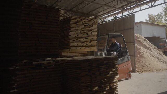 Forklift driver working in warehouse