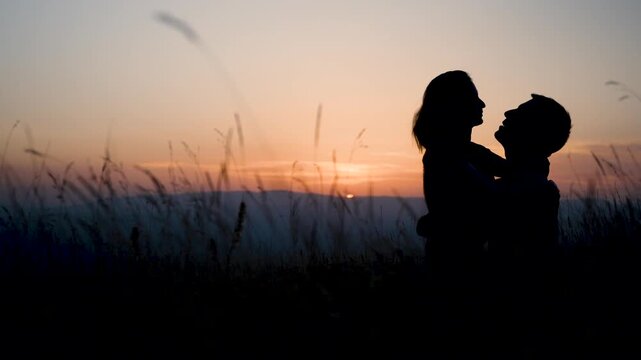 Couple making love in nature with beautiful sunset
