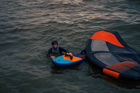 Wingfoil rider riding in the lake.