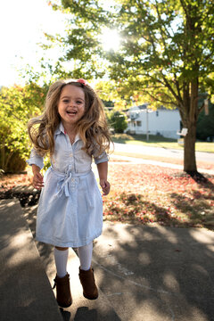 Beautiful happy little girl jumping smiling on sunny day