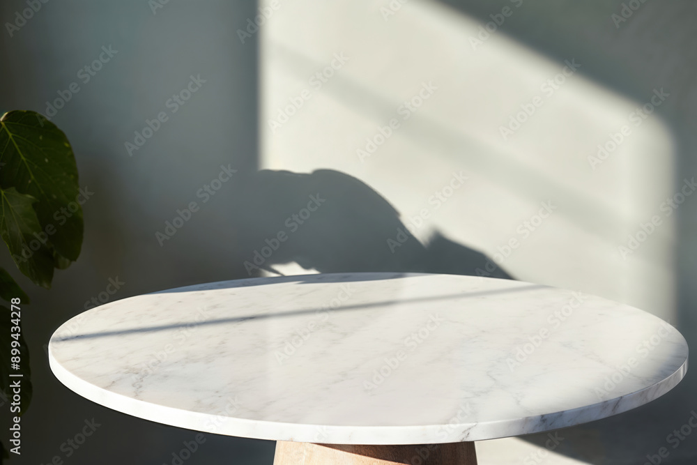 Poster empty round marble table and shadow on wall with plant