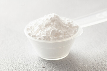Powdered magnesium oxide or sulfate in a medicine spoon, water soluble drug group