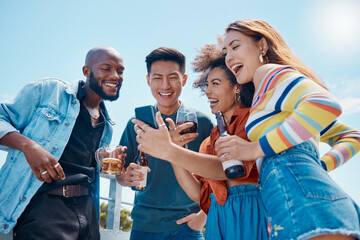 Smartphone, diversity and drinks with friends on vacation, laughing together with meme on weekend trip. Smile, happy group and multiracial people browse internet with holiday, adventure and beer