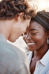 Happy, interracial and couple on beach for love, embrace and bonding together on vacation in California. Intimacy, man and woman in relationship with commitment, date and adventure in ocean with care