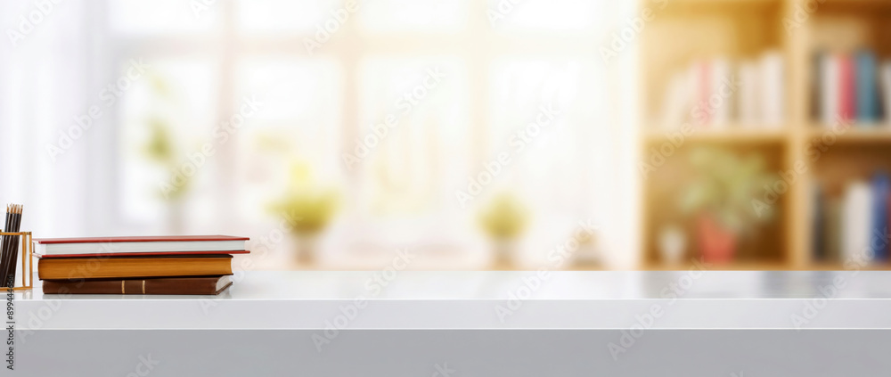 Poster White desk presenting copy space with books and pencils on top and a blurred bookshelf background