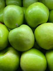 A stack of green apples in a market display