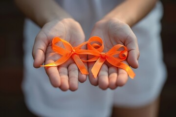 Hands Holding Orange Awareness Ribbons