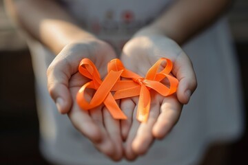 Hands Holding Orange Awareness Ribbons