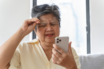 Elderly woman have eyesight problem can not read because seeing text blurred and headache from eye...