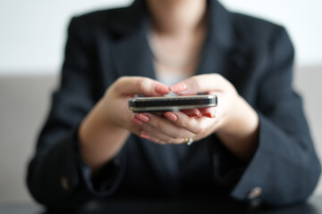 Young asian woman holding phone demonstrating for the online shopping and technology advertisement.