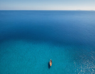 Obraz premium Aerial View of Wooden Boat on Open Blue Ocean