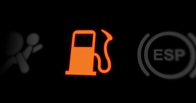 Low fuel level warning light of car dashboard, empty gasoline tank blinking indicator, close-up, footage