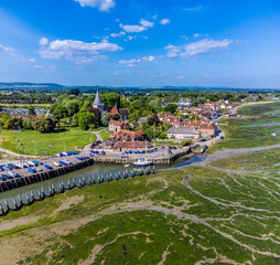 An aerial view above towards Bosham, West Sussex at low tide in summertime
