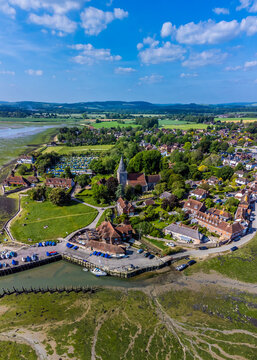 An aerial inland above the town of Bosham, West Sussex at low tide in summertime