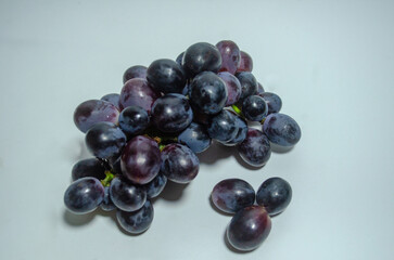 Bunch of ripe dark blue grapes Isolated on white background top view