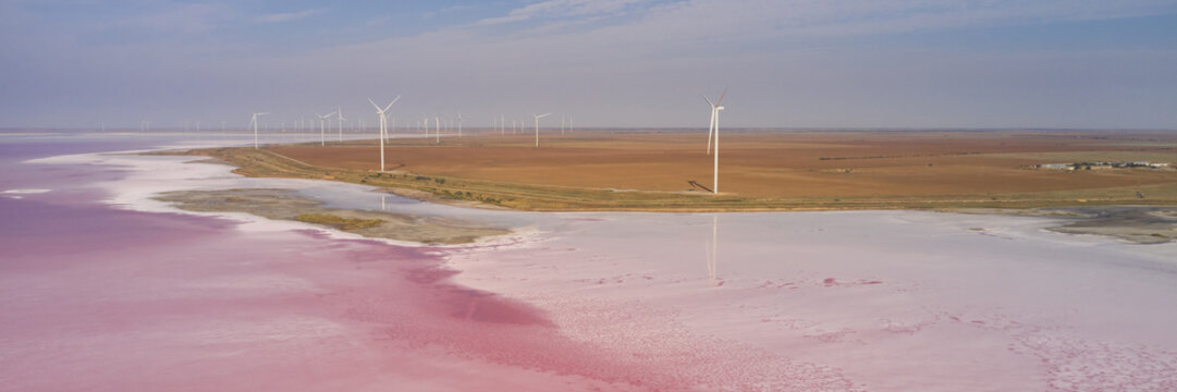 Aerial view of a wind turbines at Lemurian pink salt lake, Ukraine.