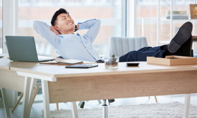 Relax, desk and businessman in office on break for finance project success with break in stock market. Corporate, smile and Asian financial analyst with rest for finished revenue report in workplace.