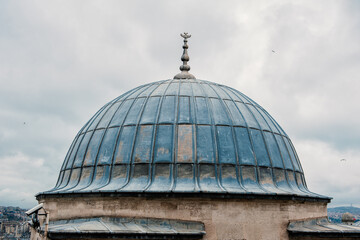 The domes of Istanbul's historical architecture stand against an overcast sky. The city's skyline...