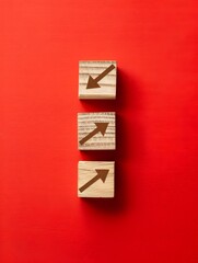 Wooden Blocks with Declining Graph and Downward Arrow on Red Background Representing Market