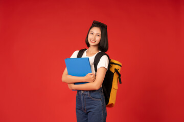 The studio photo of the Asian female student, with a vibrant red background, highlights her commitment to education, showcasing her poised demeanor and dedication to learning.