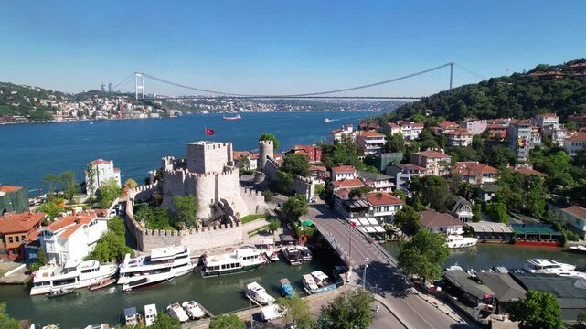 Fatih Sultan Mehmet Bridge and Anadolu Hisari (Anatolian Fortress) in Istanbul, Turkey. Beautiful Istanbul bosphorus landscape. Drone shot.