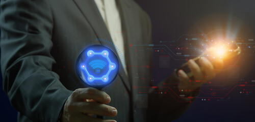 Network concept. Global internet connection technology, digital marketing, Financial and big data. Businessman showing glowing neon line of network icon in magnifying glass on virtual screen.