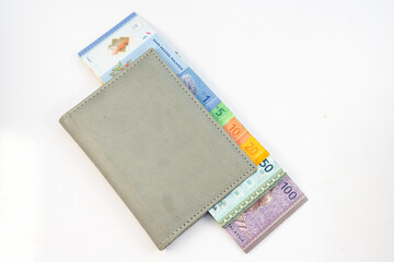 Malaysia Ringgit (MYR) RM100, RM50, RM20, RM10, RM5, RM1 in a wallet isolated on white background