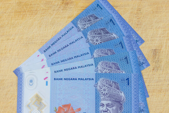 Malaysian currency, One ringgit banknote on a wooden background.