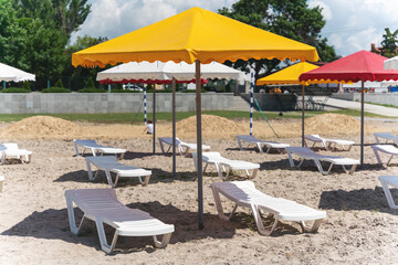 Umbrellas and sun loungers on the sea beach