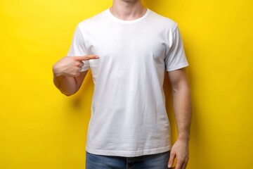 Naklejka premium Yellow background with folded blank white t-shirt, perfect for custom design and print, featuring a mockup for creative and stylish apparel branding opportunities.