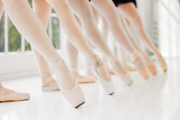 Ballerina, group and point feet for dance in theatre performance or practice for competition in art studio. Ballet, team and legs of people with learning routine for recital or talent show production