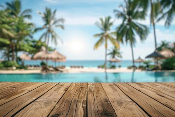 Fototapeta premium Bare wooden surface in the foreground with an out-of-focus backdrop of a tropical resort's pool, swaying palms, and ocean scenery, ideal for showcasing products and advertisements