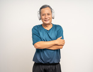 Senior asian old man with sportswear with headset on isolated white background. Portrait happy healthy fit and firm attractive sporty mature man standing pose exercise workout in studio.