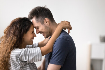 Close up side view beautiful Hispanic loving couple, embracing, enjoy moment of tenderness and...