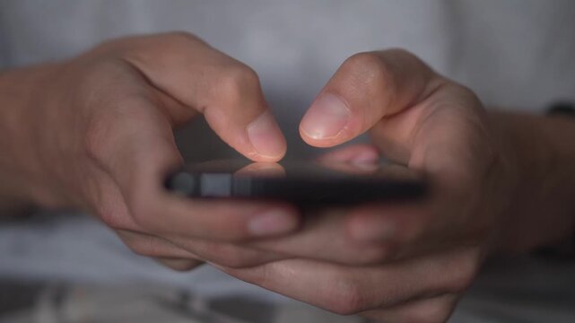 A closeup of fingers typing on a smartphone, utilizing technology for connectivity and engagement with apps and online platforms. The modern digital era enables easy access and interaction