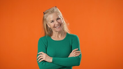 Portrait of blonde successful confident employee business mature woman 50s in green shirt casual...