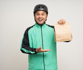 Young asian rider wearing green jacket uniform and bike helmet various action holding food paper bag delivery to customer. Male delivery service worker. Courier and shipping food service.