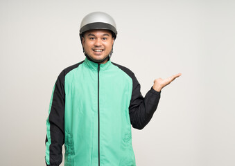 Young asian rider wearing green jacket uniform and helmet standing various action on isolated white background. Male delivery service worker. Delivery courier and shipping food service.