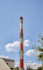 The chimney of a coal fired power plant against the sky.
