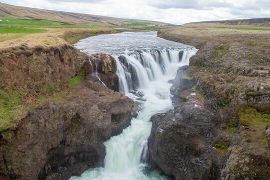 A waterfall cascade gushing down in Iceland