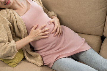 Young pregnant woman suffering stomach from abdominal pain alone female feel abnormal painful...