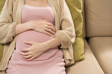 Young pregnant woman suffering stomach from abdominal pain alone female feel abnormal painful...