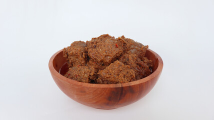 Rendang Padang. Spicy beef stew from Padang, Indonesia. The dish is arranged among the spices and herbs used in the recipe. isolated on white background