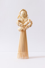 Anthropomorphic dolls (toy) is made of straw. Hand-made straw products. Straw weaving.