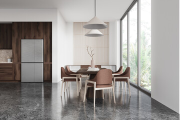 Stylish home kitchen interior with eating table and chairs, drawer and window