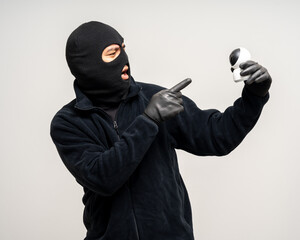 Thief in uniform black jacket various pose on isolated background. The Robber terrorism criminal...