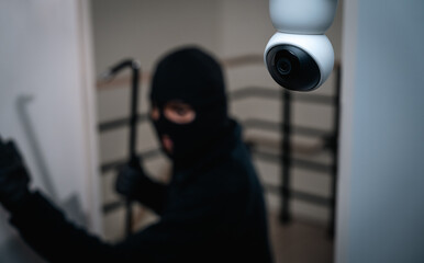 Security camera.Thief in uniform black jacket various action housebreak. The Robber terrorism...