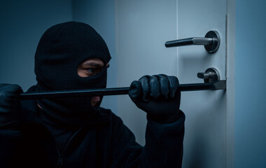 Thief in uniform black jacket various action housebreak. The Robber terrorism criminal escapes with balaclava and crowbar entering a house for stealing Housebreak at night