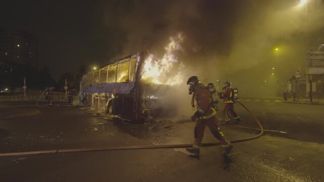 Firefighters putting out a burning bus in the night (S-Log 3, Slow motion)