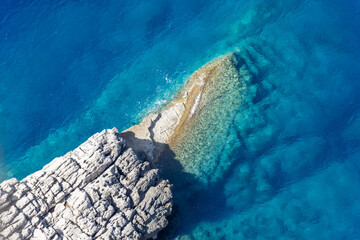 The blue sea surrounding the rock
